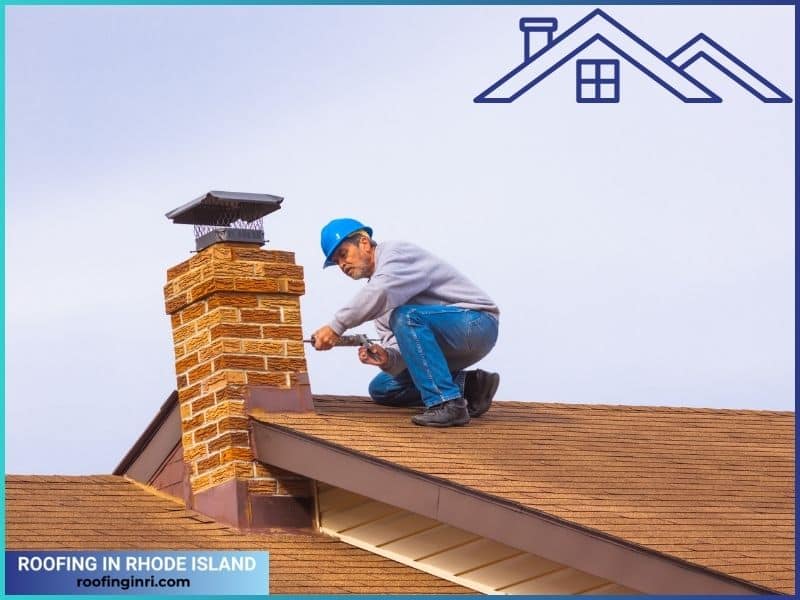 Contractor on the roof caulking chimney