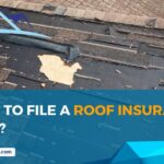 Damaged house roof with missing shingles after hurricane