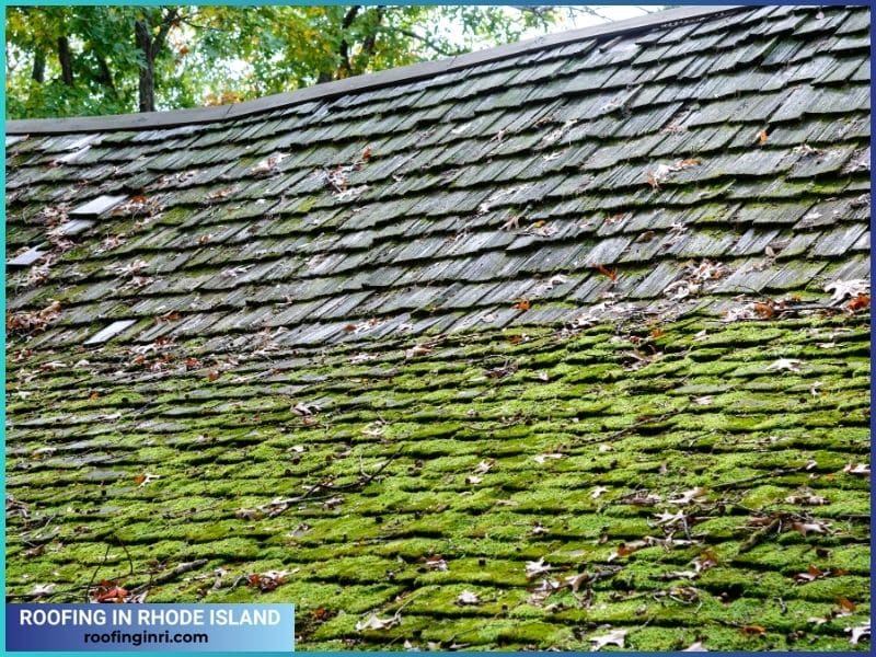 Sagging wood shake roof partially covered with moss