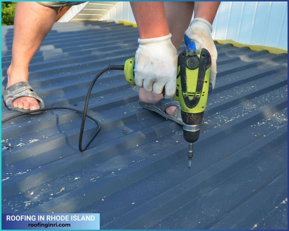  A roofing contractor is installing metal roofing sheets