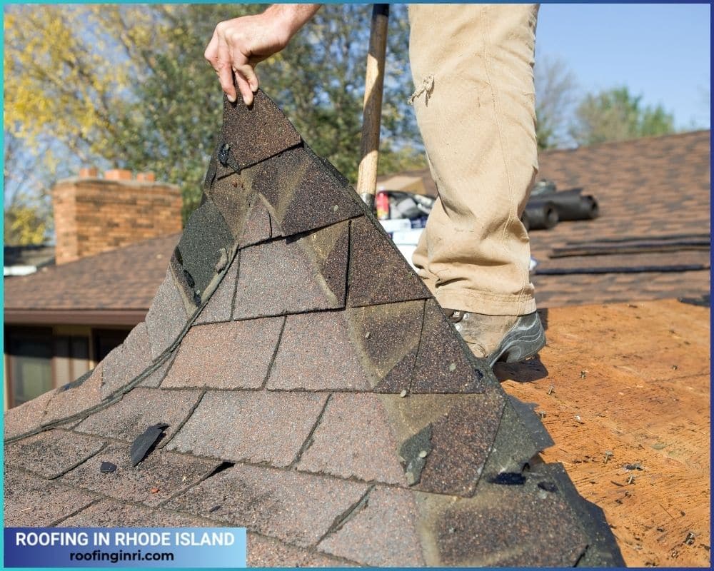 Worker Removing Old Roof Shingles for Replacement