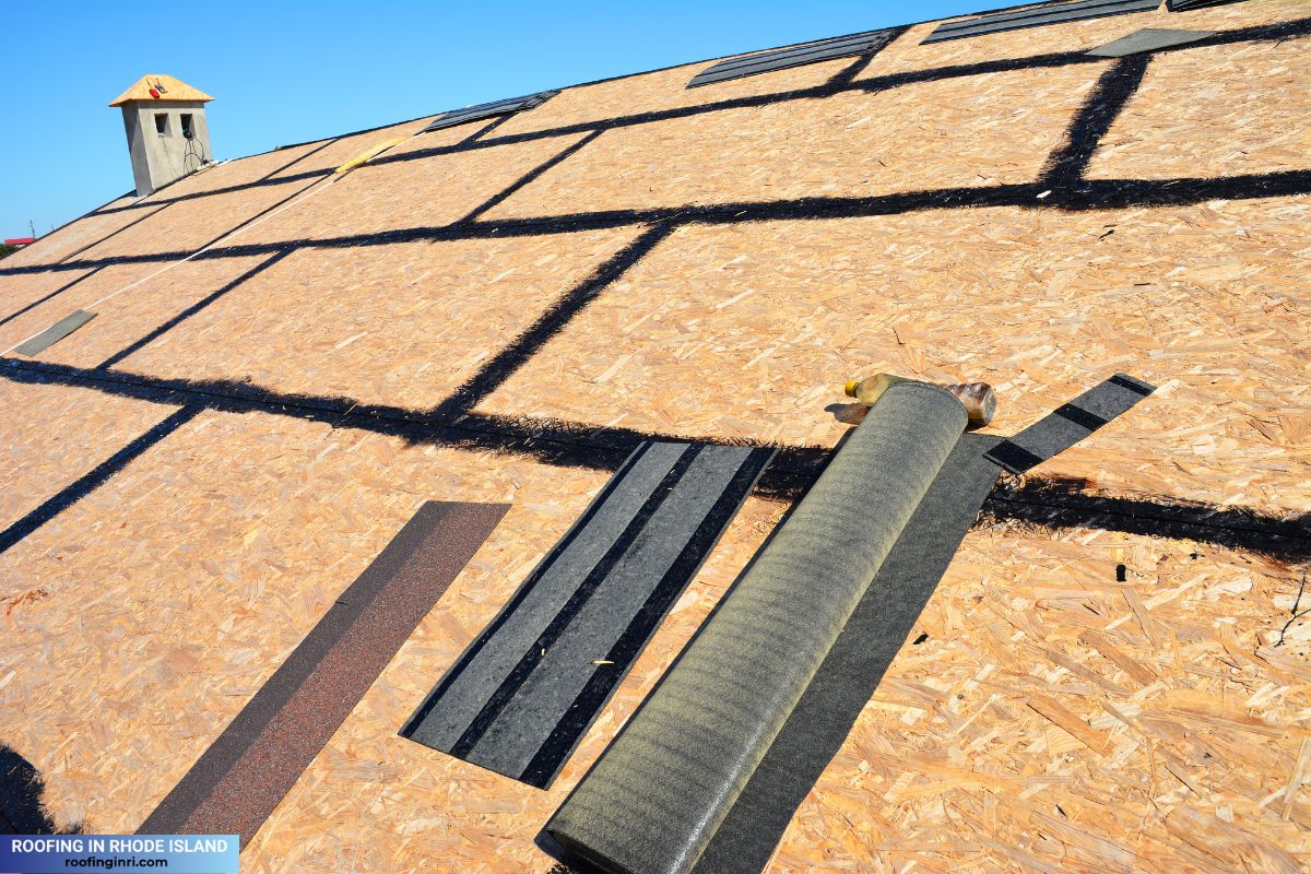 Roofing construction. Preparing a osb roof deck with bitumen waterproofing in cracks before underlayment, felt paper and asphalt shingles installation.
