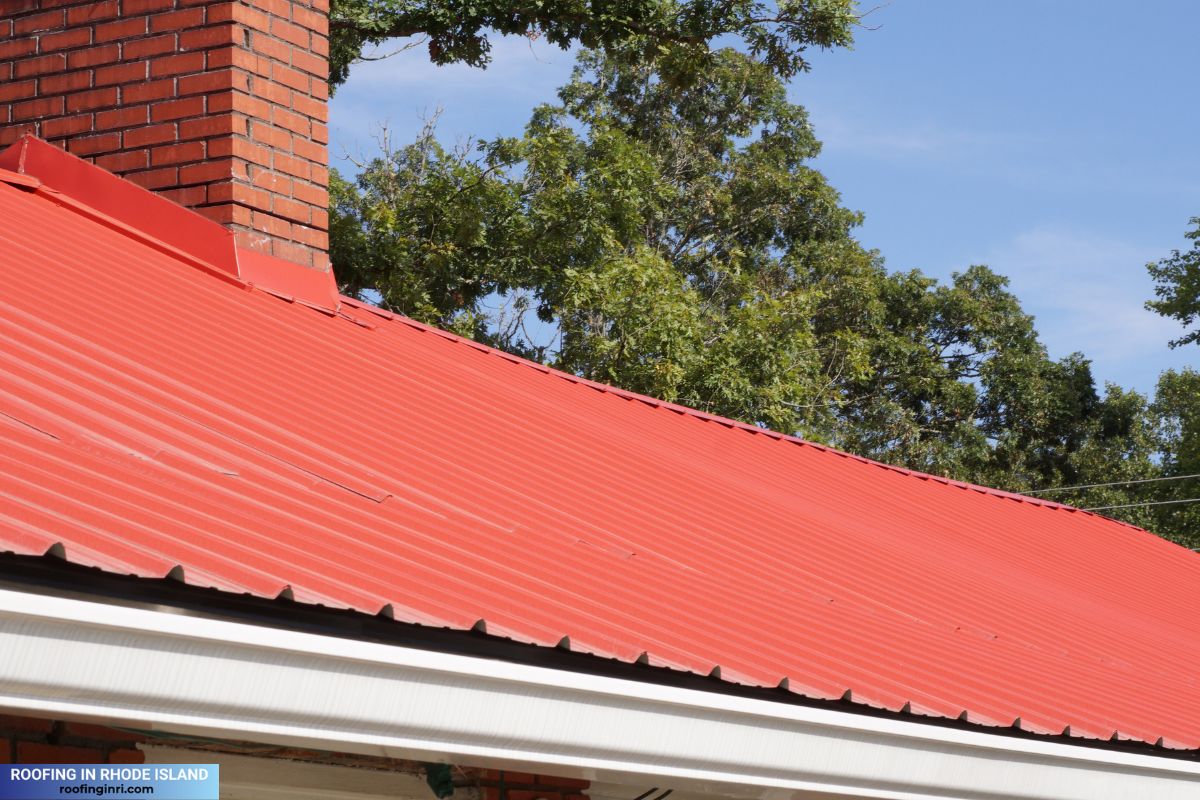 Red metal roof with chimney and flashing